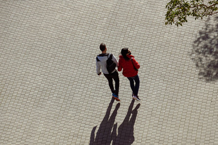 couple walking around on the street in bilbao city, basque country, spain, travel destinationsの写真素材