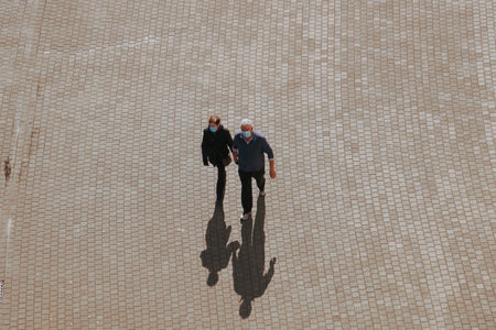 couple walking around on the street in bilbao city, basque country, spain, travel destinationsの写真素材