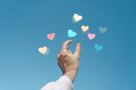 hand up in the sky touching a heart shape, love emotions in valentine's dayの写真素材