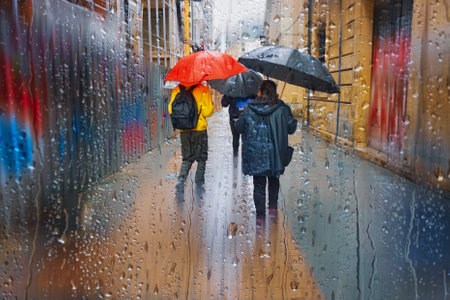 people with an umbrella in rainy days, bilbao, basque country, spainの写真素材