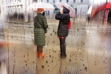 people with an umbrella in rainy days, autumn season, in Bilbao city, Basque country, Spainの写真素材