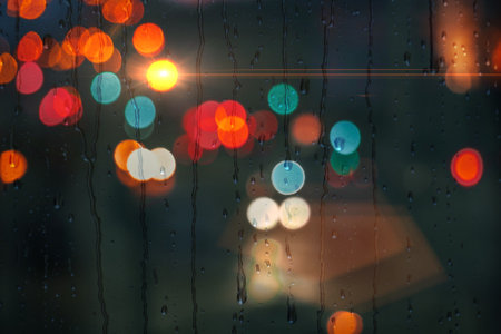 raindrops on the window in rainy days and street lights backgroundの写真素材