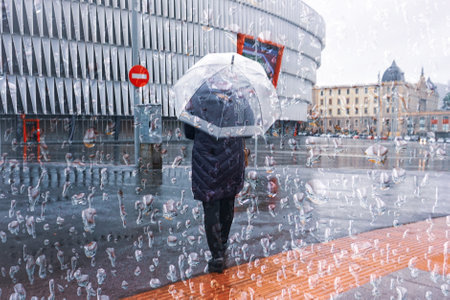 people with an umbrella in rainy days in Bilbao city, basque country, spain
