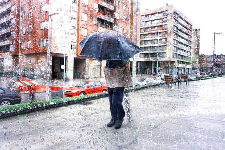 people with an umbrella in rainy days in Bilbao city, basque country, spainの写真素材