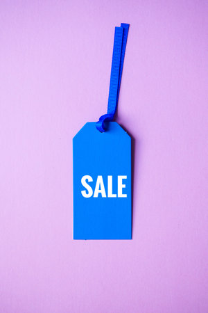 blue price tag with sale word on the pink background, blue mockupの写真素材