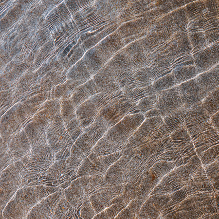 Close up of water ripples on a stone surface. Abstract background.の写真素材
