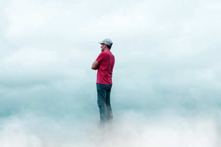Man standing on top of the mountain and looking at the view.の写真素材