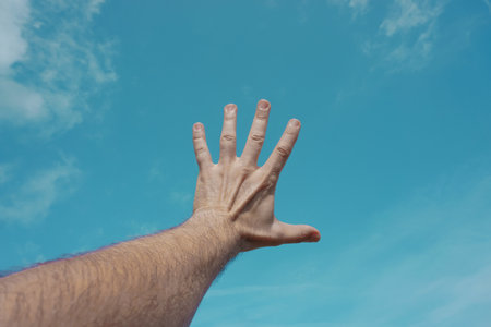 <p>hand up gesturing in the blue sky, feelings and emotions</p>の写真素材