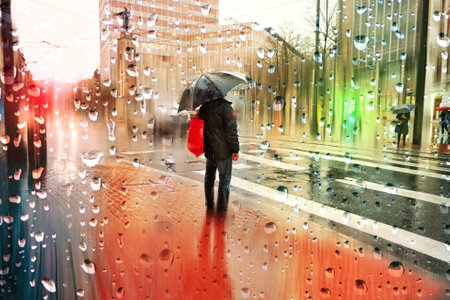 people with an umbrella in rainy days in winter season, bilbao, basque country, spainの写真素材