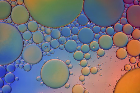 multi colored oil circles on the water, colorful backgroundの写真素材