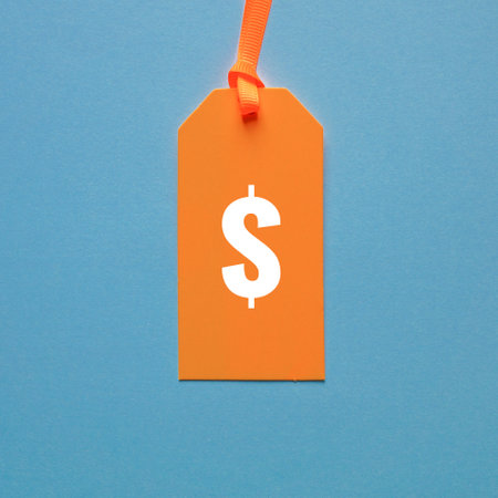dollar symbol in orange price tag on blue backgroundの写真素材