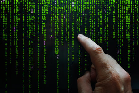 index finger pointing at digital screen, binary code