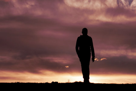 Silhouette of a man on the sunset background. Conceptual photo.の写真素材