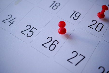 Red pin on calendar page. Business planning concept. Selective focus.