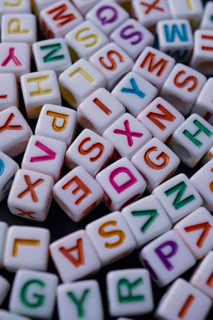 Close up of colorful alphabet blocks on black background. Education concept.