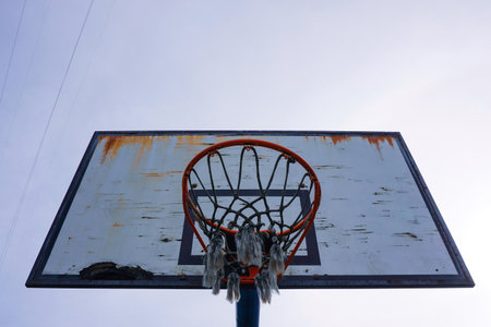 Basketball hoop and net on blue sky background. Street basketball court.