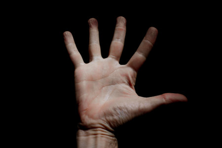 Human hand on a black background. Studio shot. The concept of the movement of people.