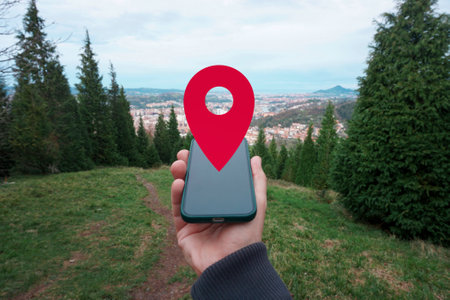 Smartphone with location pointer in handの写真素材