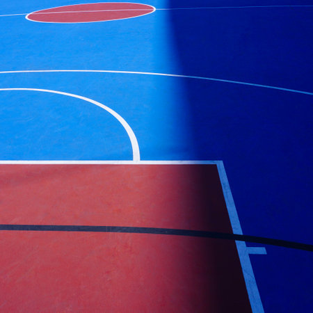 Blue and red basketball court floor with white lines, closeup of photoの写真素材