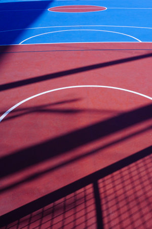 blue and red basketball court with white lines, closeup of photoの写真素材