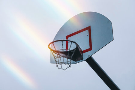 Basketball hoop and net with rainbow effect on background.の写真素材