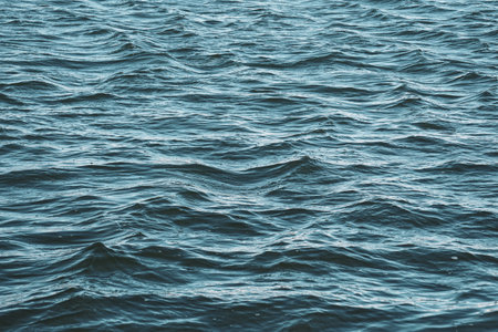 Blue sea water texture background. Close up of blue sea water surfaceの写真素材