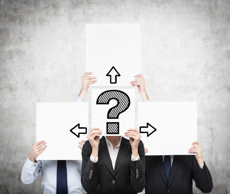 businesspeople holding paper with drawing question mark and arrowの写真素材