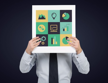 businessman holding placard with business iconsの写真素材
