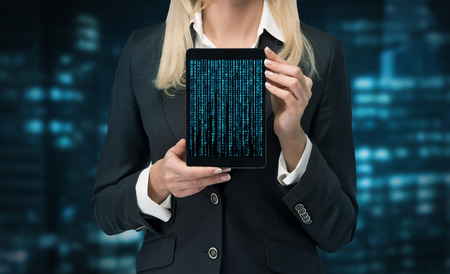 businesswoman holding touch pad with cyberspaceの写真素材
