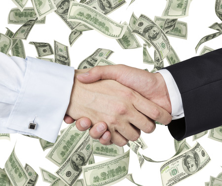 handshake on a dollar falling banknote backgroundの写真素材