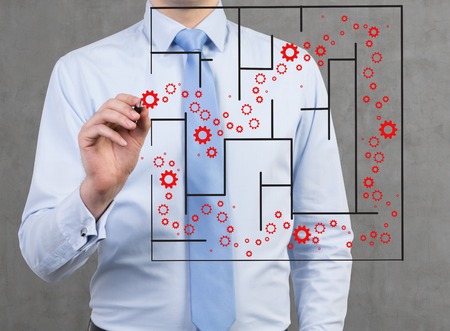 businessman drawing gears way in labyrinthの写真素材