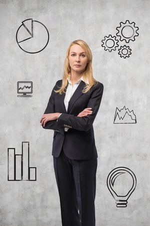 businesswoman thinking and drawing business icon on handの写真素材