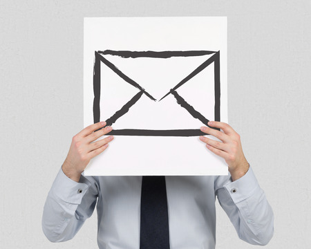 businessman holding banner with drawing mailの写真素材