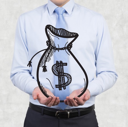 businessman holding drawing money bags in handの写真素材