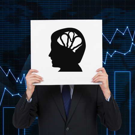 businessman holding poster with silhouette of  headの写真素材
