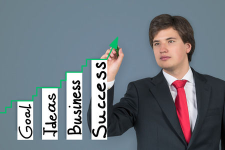 businessman drawing chart on gray backgroundの写真素材