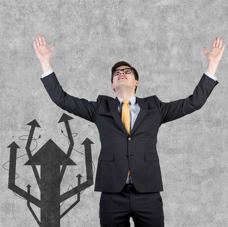 happy businessman and drawing arrow tree on wallの写真素材