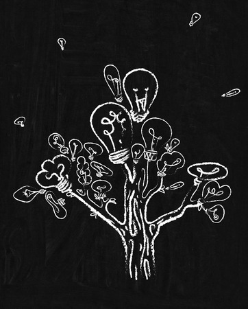 tree with lamp bulb drawing on blackboardの写真素材