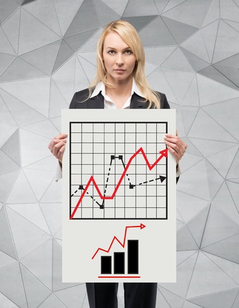 businesswoman holding poster with chart, close upの写真素材