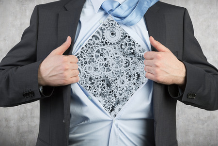 businessman tearing his shirt with red cogs and gears