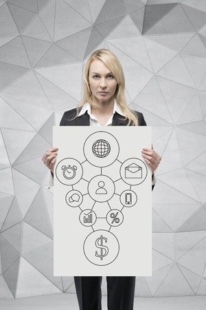 businesswoman holding poster with drawing business map on wallの写真素材
