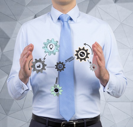 businessman holding drawing cogwheel and gearsの写真素材