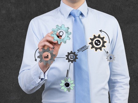 businessman drawing cogwheel and gears iconの写真素材