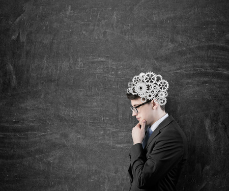 businessman thinking with silver gears on headの写真素材