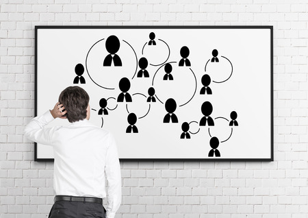 businessman in room looking to blackboard with social media iconの写真素材