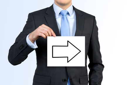 businessman holding white poster with drawing arrowの写真素材