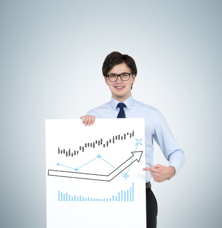 businessman holding poster with drawing arrows and chartの写真素材