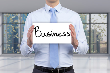 businessman holding paper with drawing business textの写真素材