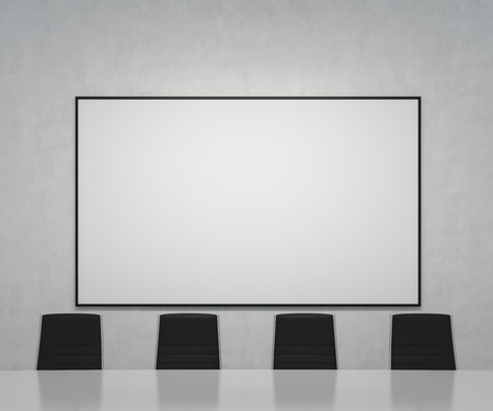 office with big blank poster on wallの写真素材