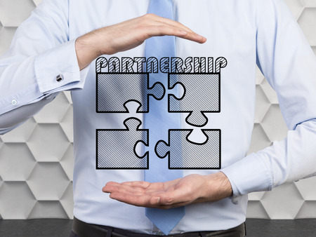 businessman holding four puzzle,  partnership conceptの写真素材